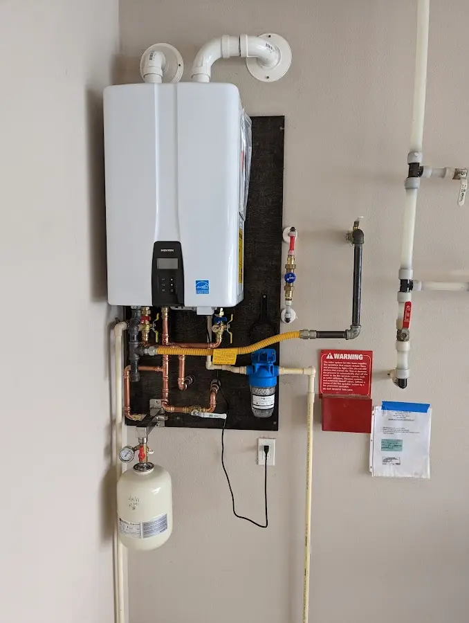 Professional plumber installing copper piping in a Grenada home